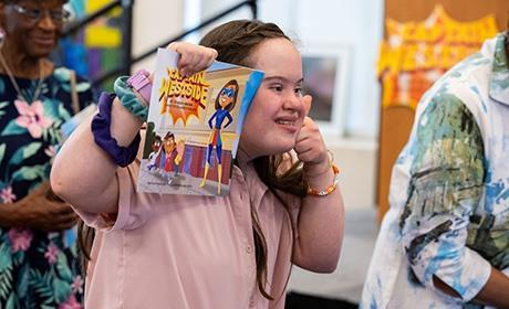 Child holding Captain Westside book