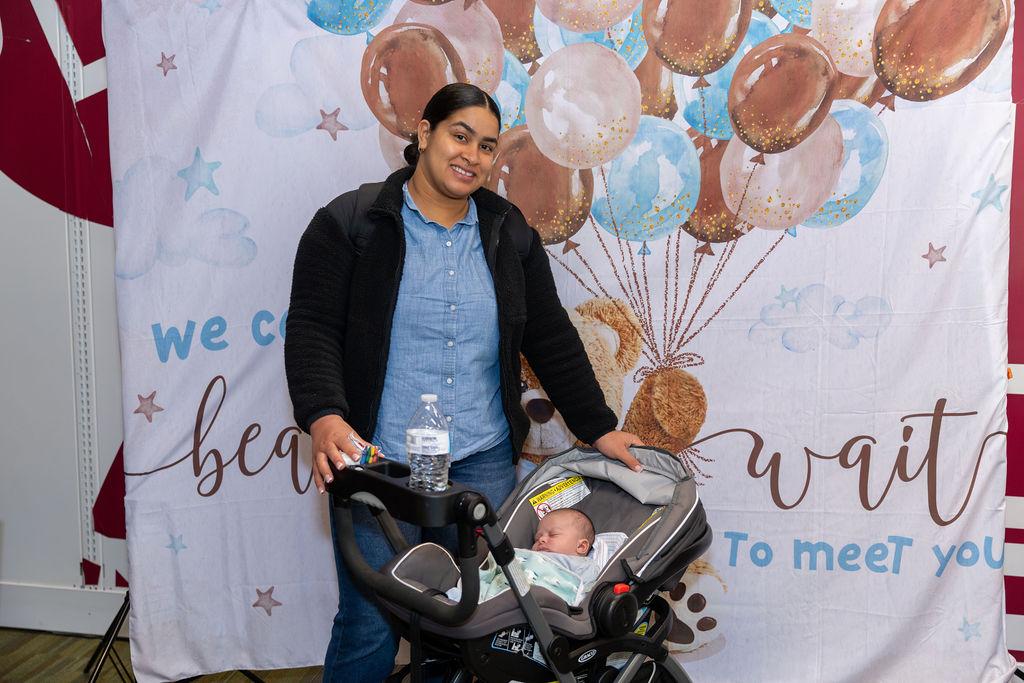 Mother standing with her baby at a community baby shower